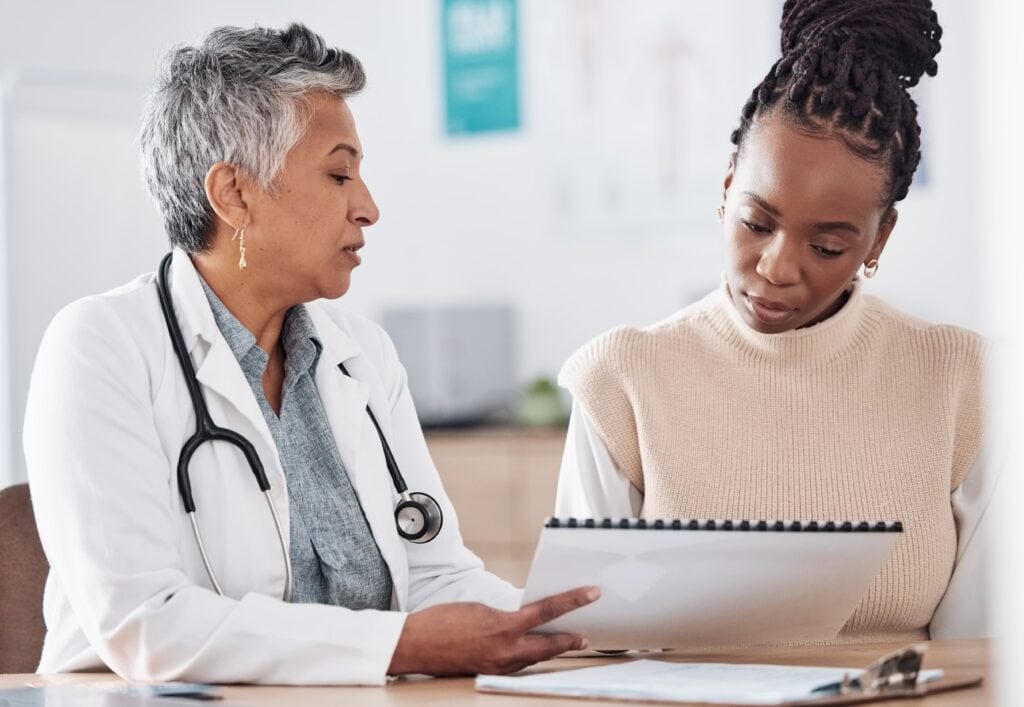 Doctor discussing treatment options with a patient, illustrating personalized care for weight loss solutions like Tirzepatide and Semaglutide at Premiere Concierge & Wellness.