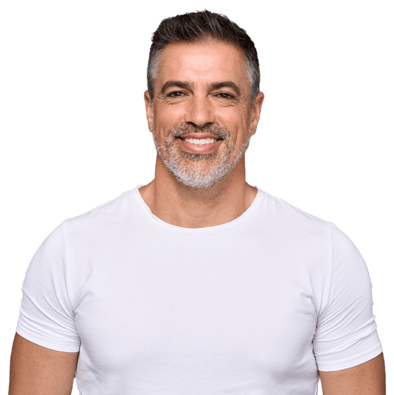 A smiling man with healthy, youthful skin and vibrant hair, showcasing the benefits of PRP and Exosomes at Premiere Concierge & Wellness.
